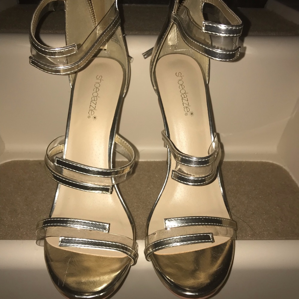 Brand new. Never worn.Gold and clear sandals.